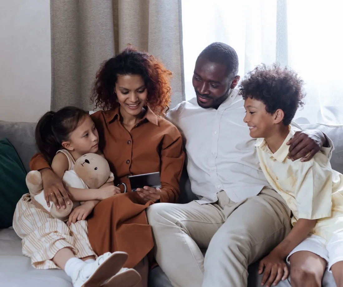 Smiling family relaxing together at home